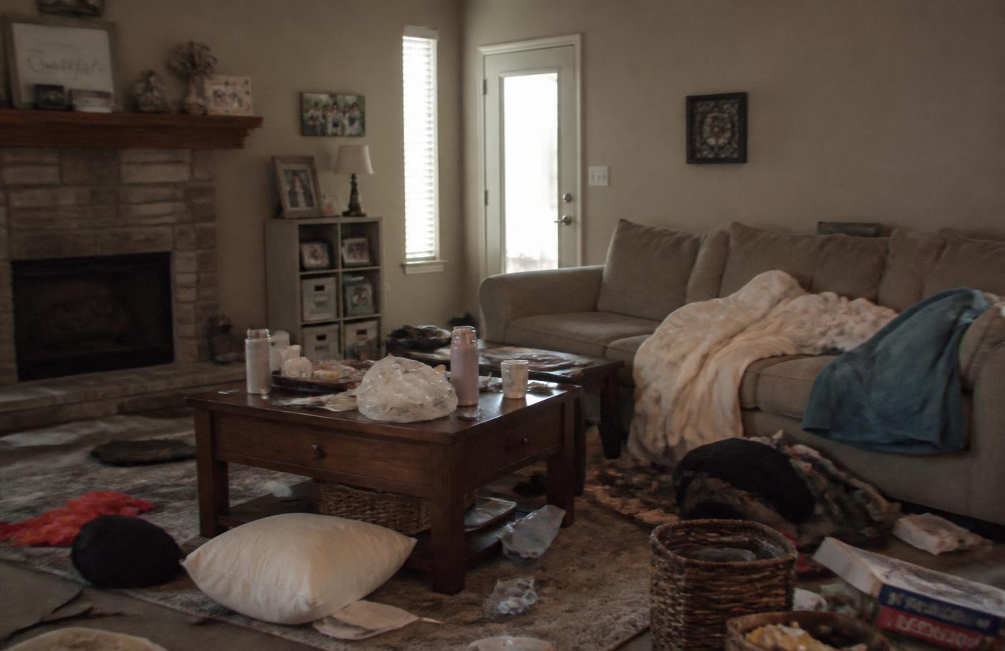 The same living room before cleaning, cluttered and dull